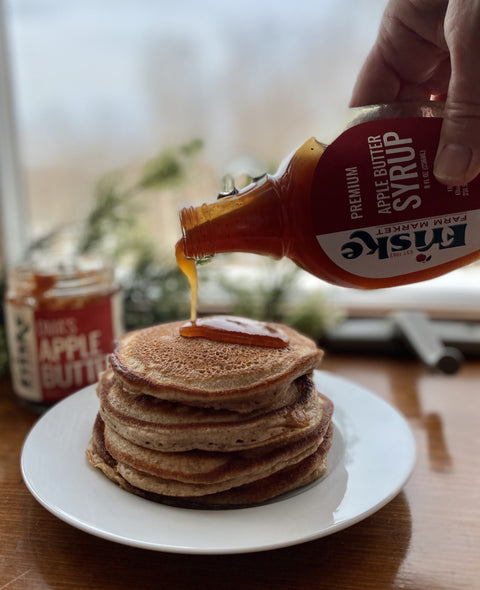 Syrup pouring over stack of pancakes, maple syrup,