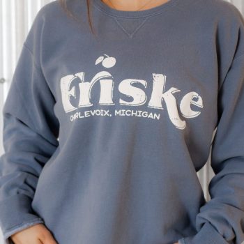 Evelyn Friske wearing Frontier Blue crewneck sweatshirt with Friske Logo